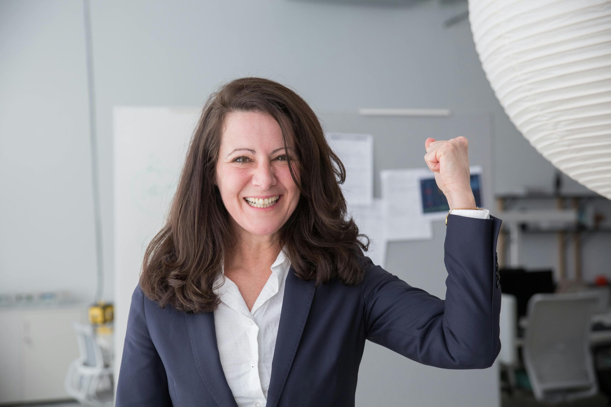 Confident woman in her 40s working on her laptop, rebranding her career for a new chapter
